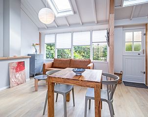 Lichte zithoek in vakantiehuis Pippa, De Koog, Texel met comfortabele bank en eettafel.