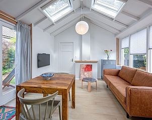 Ruime woonkamer in vakantiehuis Pippa, De Koog, Texel met uitzicht op de tuin.