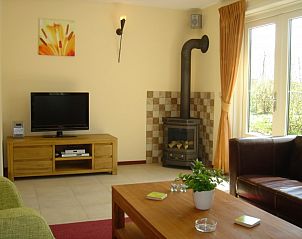 Bright living area with wood-burning stove in 6-pers. Vacation home with sauna in De Koog, Texel, Wadden Islands.