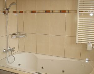 Spacious bathtub in bathroom of 6-pers. Vacation home with sauna in De Koog, Texel, Wadden Islands.
