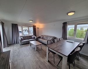 Ruime woonkamer in Chaletpark Bregkoog - Chalet 240 De Texelse Berg, De Koog, Texel met comfortabele zithoek en eethoek.