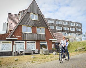Exterior of Grand Hotel Opduin - Holiday Apartment A in De Koog, Texel, surrounded by natural beauty and bicycle paths.