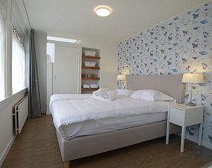 Luxury bedroom in Grand Hotel Opduin - Holiday home A, De Koog, Texel, with butterfly wallpaper and cozy beds.