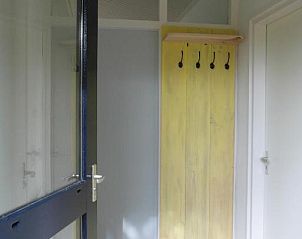Entree van Zeealsem vakantiehuis in Ballum, Ameland met kapstok en tegelvloer.