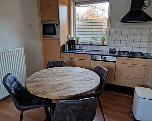 Gezellige woonkamer van Bungalow 3440 - SUPER in Den Burg, Texel met comfortabele zitruimte en tv.