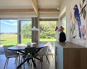 Dining area with view at 45 - 't Veldje, vacation home in Den Hoorn, Texel.