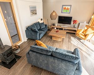 Cozy sitting area with wood stove in vacation home Sil in Den Hoorn, Texel for cozy evenings.