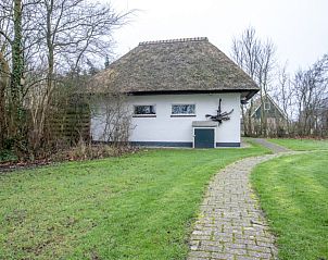 Rustige omgeving van vakantiehuis Nieuwlanderweg 69 in De Koog, Texel, met een kronkelend pad door de tuin.