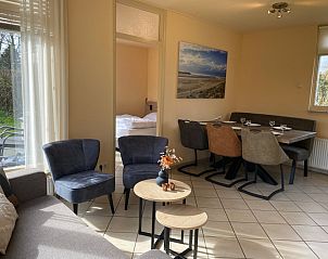 Cozy indoor area of vacation home Noordzee in Oosterend, Texel with dining and sitting area.