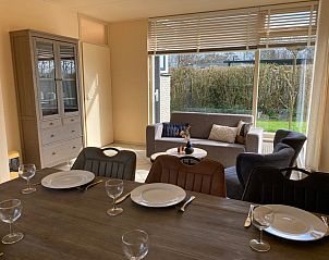 Sunny living room of vacation home Noordzee in Oosterend, Texel with comfortable sofa.