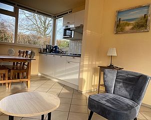 Modern kitchen in Wadden Sea vacation home Texel with dining area.