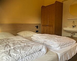 Bedroom with double bed in Wadden Sea vacation home Texel.