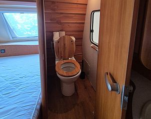 Innenraum eines Wohnwagens mit Vorzelt in Oosterend, Texel. Kompaktes Badezimmer neben dem gemtlichen Schlafzimmer in dieser Ferienunterkunft auf den Watteninseln.