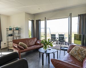Wohnzimmer des Ferienhauses Duunkruud in Zuid-Eierland, Texel, mit Zugang zur Terrasse.