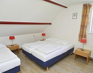 Gemtliches Schlafzimmer im Ferienhaus De Oorsprong, Zuid-Eierland, Texel mit drei Betten und Dachschrge.