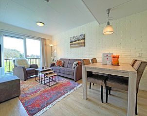 Gemtliches Wohnzimmer im Apartment Bos en Duin 31, De Dennen, Texel mit bequemem Sofa und Blick auf die Natur.