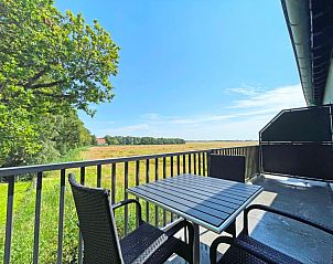 Terras van Appartement Bos en Duin 32, De Dennen, Texel met prachtig uitzicht op de groene omgeving en comfortabele zitplaatsen.