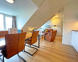 Dining room with wooden table in Apartment Bos en Duin 34, De Dennen, Texel.