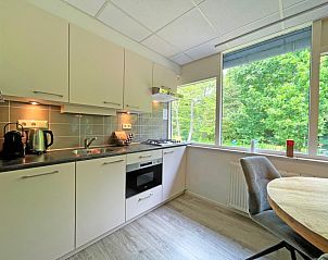 Eethoek met uitzicht op de natuur in Appartement Bos en Duin 23, De Dennen op Texel, perfect voor gezellige diners.