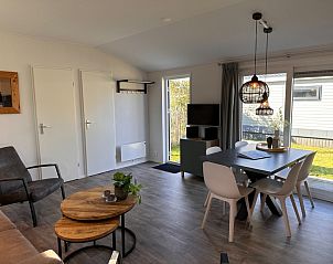 Gemtliches Wohnzimmer im Ferienhaus Vakantiepark de Bremakker, Bosveld 128, De Dennen, Texel, mit moderner Einrichtung und Blick auf den Garten.