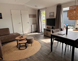 Helles Wohnzimmer von Chalet Wulk im Vakantiepark de Bremakker, Texel, mit Zugang zur Terrasse und moderner Einrichtung.