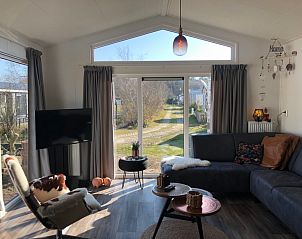 Gezellige woonkamer bij Vakantiepark de Bremakker - Bosveld 121 in De Dennen, Texel met uitzicht op de natuur.