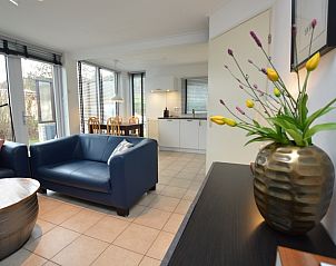 Moderne inrichting in Vakantiehuis de Parel 244, De Dennen, Texel met bloemen en stijlvolle details.