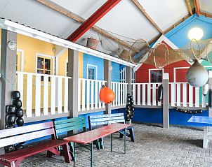 Playful recreation room in Holiday Park de Bremakker Weideveld 61, Texel, vacation home in De Dennen with colorful furnishings.
