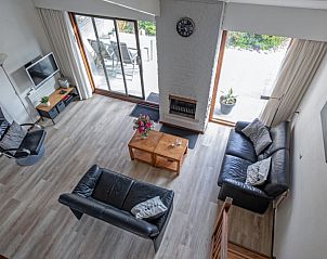 Uitzicht van bovenaf op woonkamer Vakantiehuis Gortersmient 228 Texel met terras.