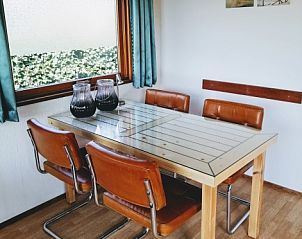 Eetruimte in Vakantiepark De Koorn-aar - Chalet 102 type C, De Dennen, Texel met moderne tafel en stoelen, ideaal voor gezellige maaltijden.