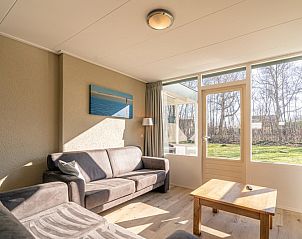 Ferienhaus de Parel 166, Texel. Sonniges Wohnzimmer mit Zugang zum Garten, ideal zum Entspannen in De Dennen.