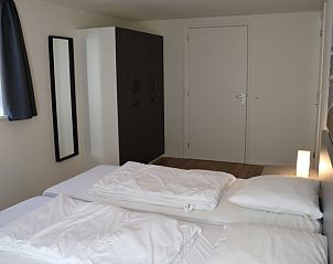 Comfortabele slaapkamer in Vakantiehuis Gortersmient 232, De Dennen, Texel met tweepersoonsbed en kast.