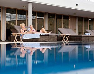 Gasten ontspannen bij het zwembad van WestCord Strandhotel Seeduyn, Vlieland.
