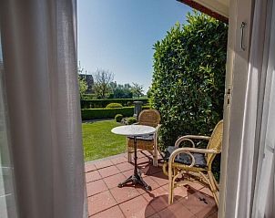 Privterras met tuinzicht in Villa Magnolia, vakantiehuis in Oostkapelle, Walcheren, ideaal voor koffie in de ochtend.