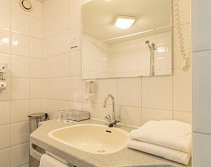 Stijlvolle badkamer in Fletcher Resort-Hotel Amelander Kaap, Hollum, Ameland met moderne voorzieningen en elegante afwerking.