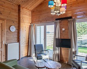 Gezellige woonkamer van Finse bungalow 5 personen in Hee, Terschelling met houten interieur en veel licht.