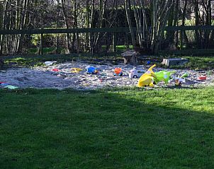 Sandbox with toys in the garden of De Zicht apartment, West Terschelling.