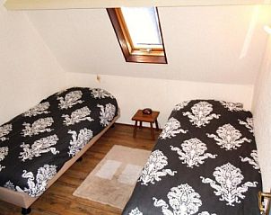 Attractive bedroom with two beds in apartment Havenzicht, West, Terschelling, perfect for a good night's sleep after a day of exploring.