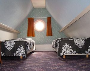 Spacious bedroom with skylight in apartment Havenzicht, West, Terschelling, offers comfort and tranquility on the Wadden Islands.