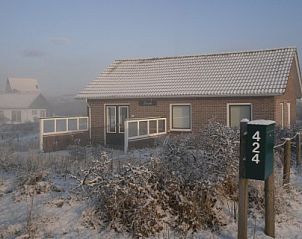 Snow covered vacation home Pirola in Midsland aan Zee, Terschelling, for a winter vacation.