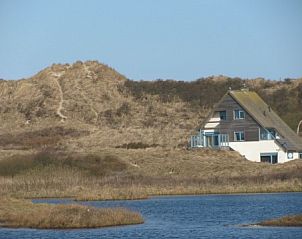 Nij Jit vacation home on a lake in Midsland aan Zee Terschelling, surrounded by dunes.