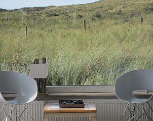 Quiet sitting area in Nij Jit vacation home, Midsland aan Zee Terschelling, overlooking green dunes.