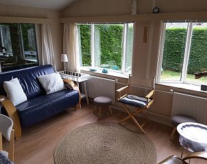 Knusse woonkamer in Koekoeksdne chalet, Midsland Noord, Terschelling met uitzicht op tuin.