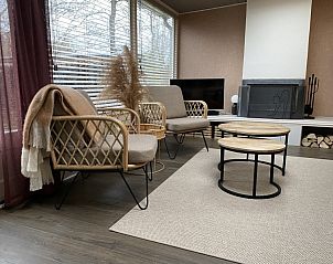 Cozy indoor area of Holiday Home Belhamel in Midsland Noord, Terschelling with comfortable seating and large windows.