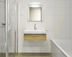 Moderne badkamer met douche en bad in het 4-6L appartement, West-Terschelling.