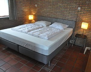 Comfortable bedroom in Jans bungalow, Ballum, Ameland, with double bed and mood lighting.