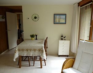 Dining area in Thuishaven vacation home, Ballum, Ameland, with wooden accents.