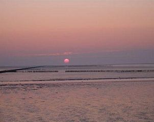 Breathtaking sunset at Albatros, Ballum, Ameland overlooking the serene Wadden Sea.