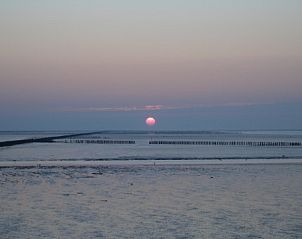 Beautiful evening sky at bungalow Albatros, Ballum, Ameland with sunset over the Wadden Sea.