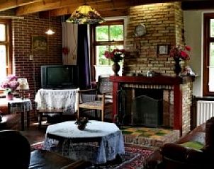 Ruime woonkamer van vakantiehuis Suzan in Ballum, Ameland met authentieke details, ideaal voor een familieverblijf op de Waddeneilanden.